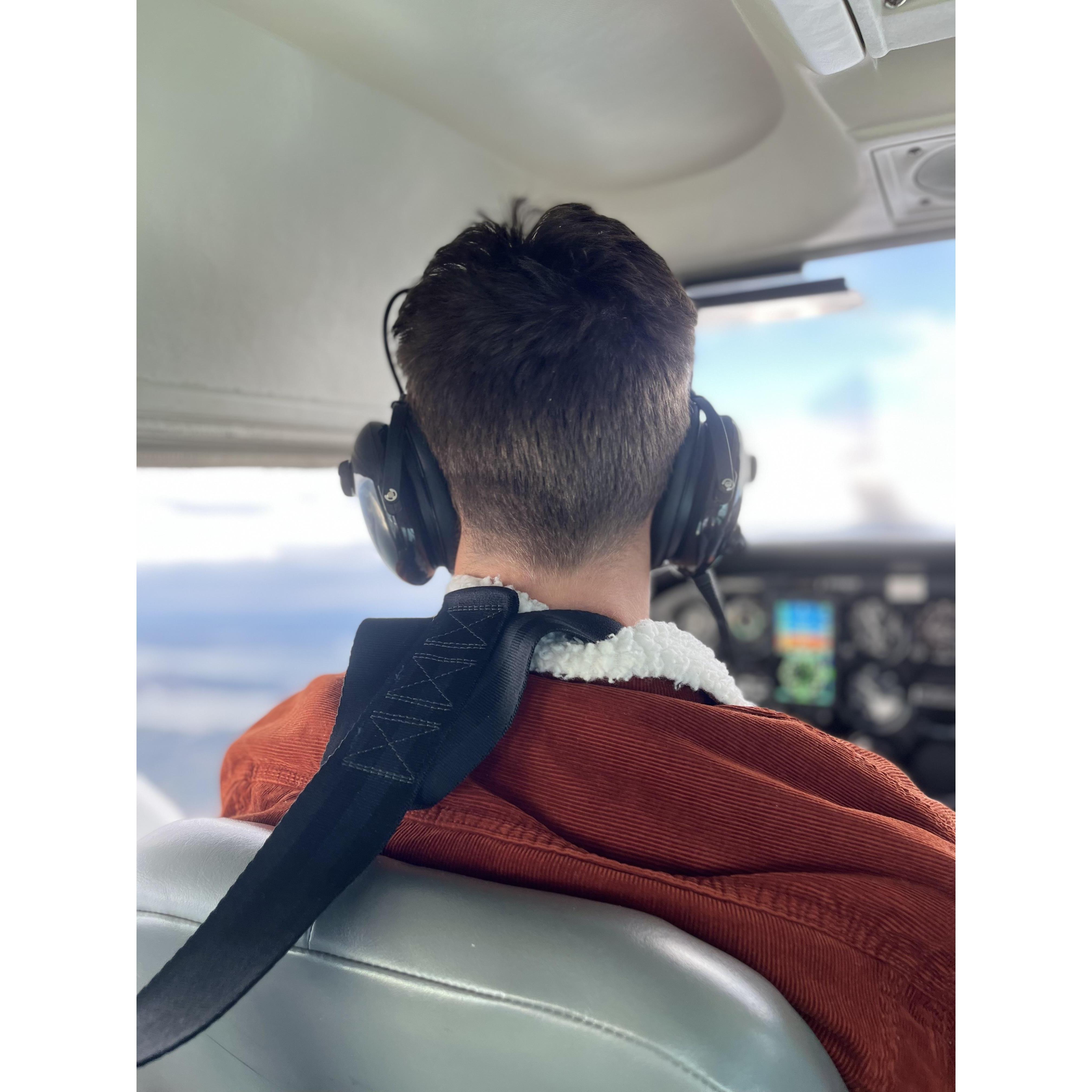 Titus flying the plane on the way to propose