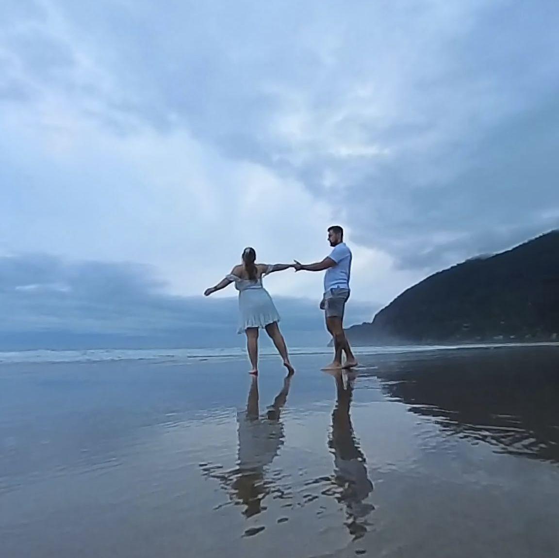 Dancing on the beach just moments before he popped the question!