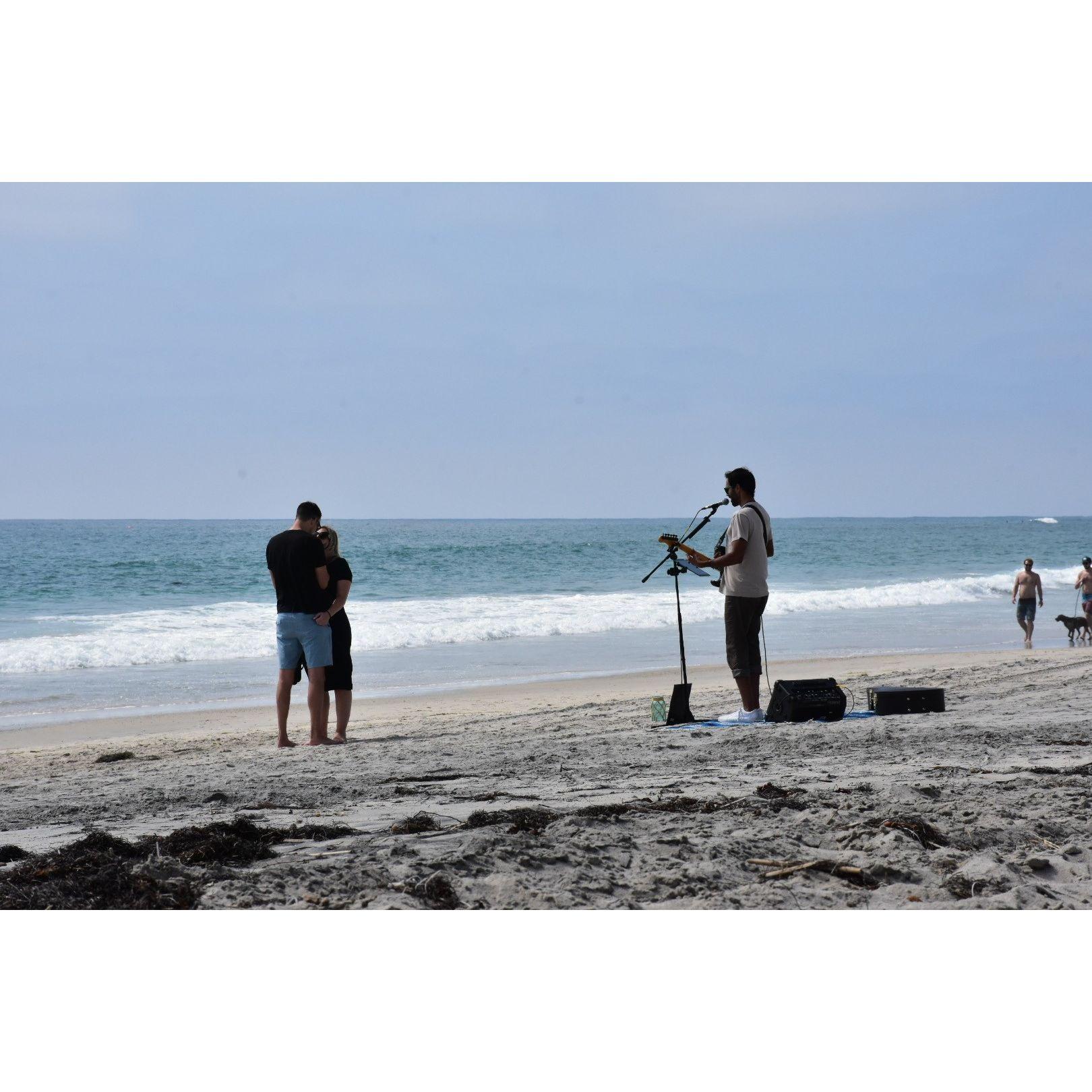 Our engagement on Cardiff Beach. It wasn't until the guitarist started playing our song that I finally realized what was happening.