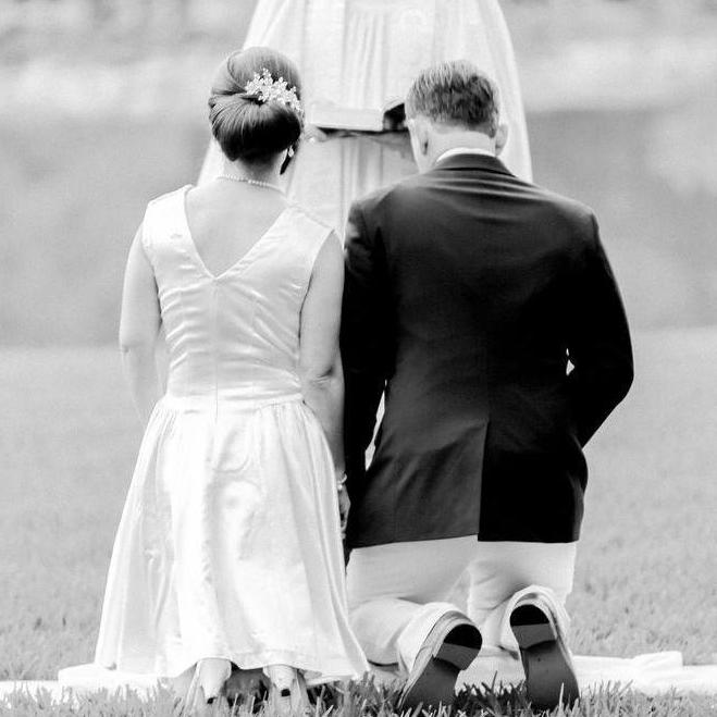 Saying our prayers on the family kneeling pillow at the end of the wedding ceremony.