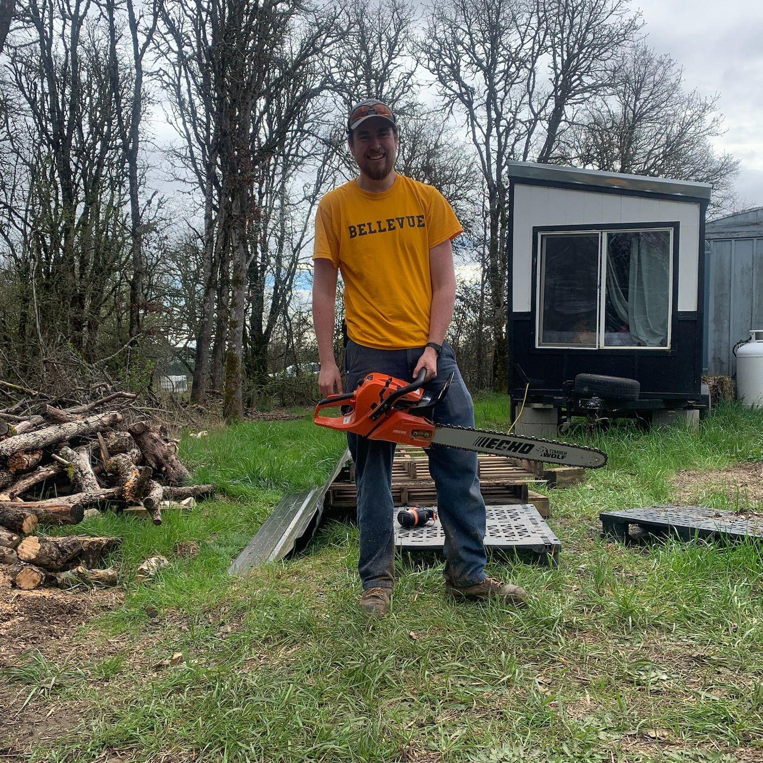 Henry bucking firewood rounds on the Emmaus service trip.