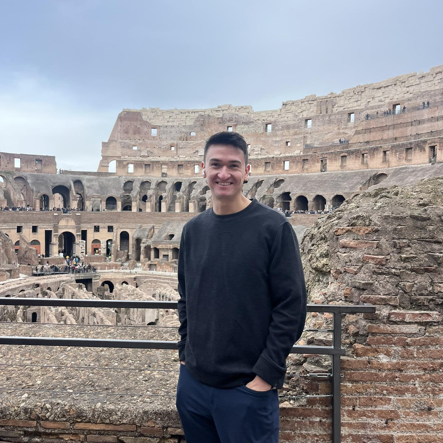 Colosseum - Ryan (begrudgingly) getting a photo between audio tour episodes and crowds of students