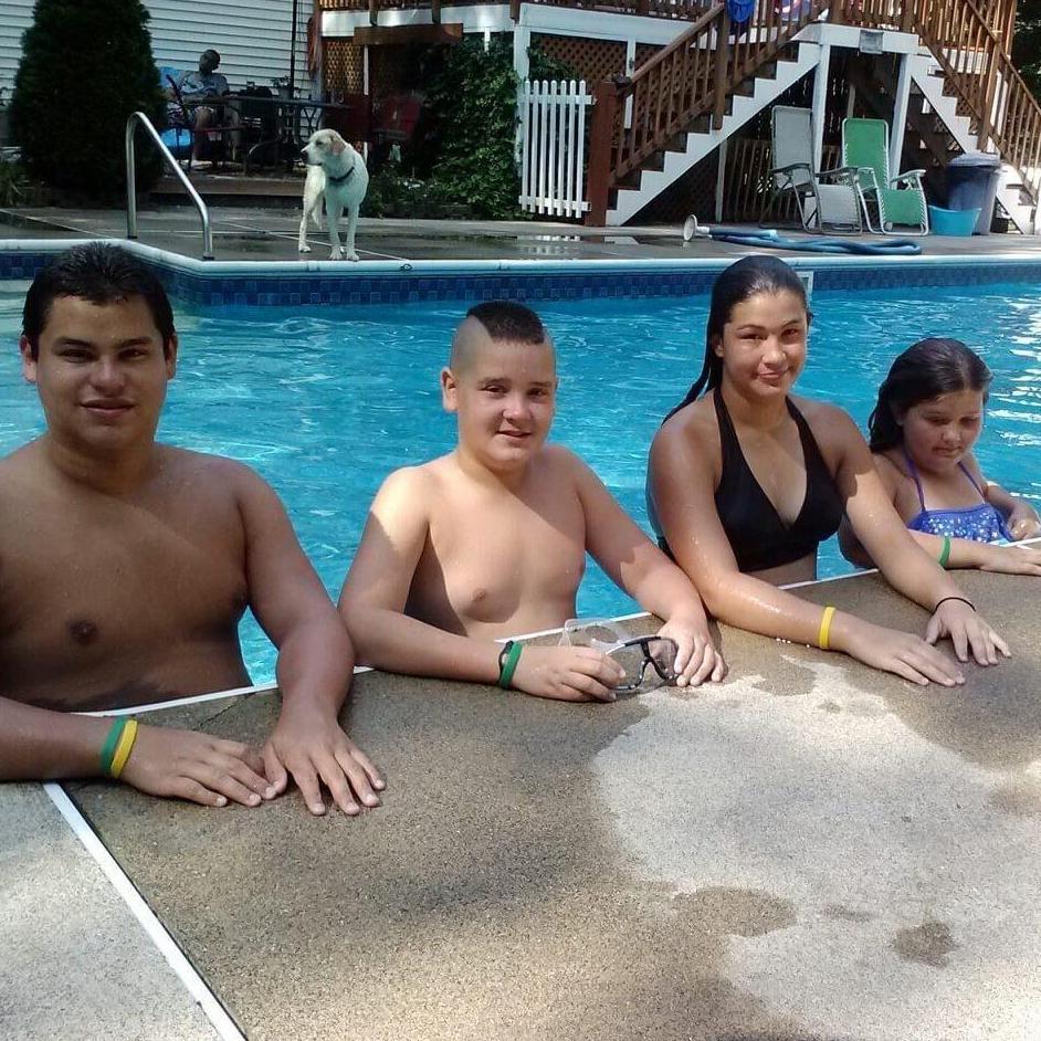 Tyler, Kevin, Kayla, & Caitlin having a pool day. Also sweet Buddy dog in the back :)