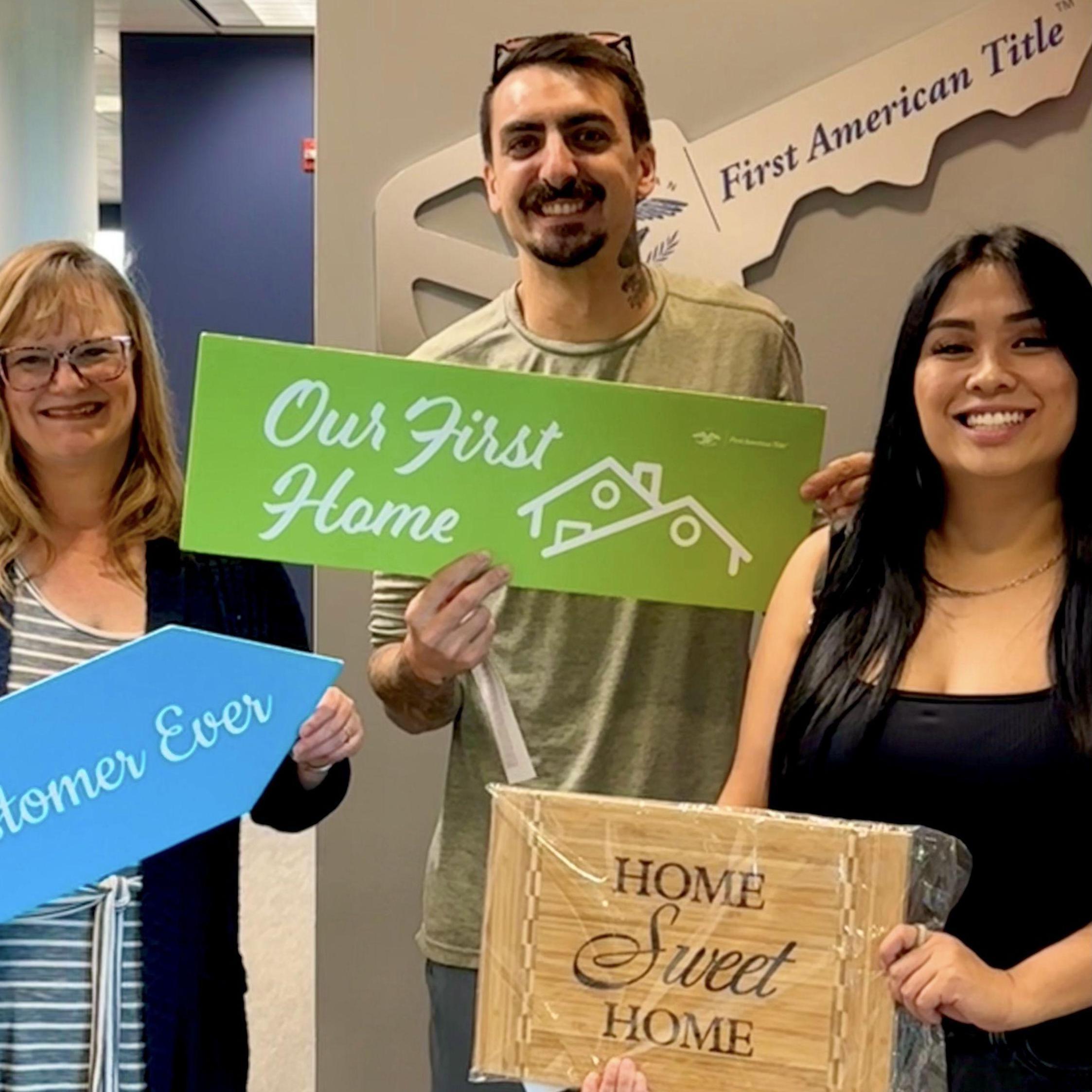 The day they signed the paperwork for the house with their Loan Officer Paula who will also be attending the wedding!