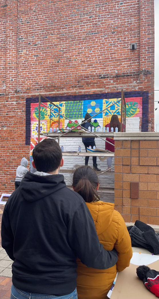 Photo of us when our Honors Art Class went off campus to paint our semester project mural. A classmate thought we were cute and snapped this pic.