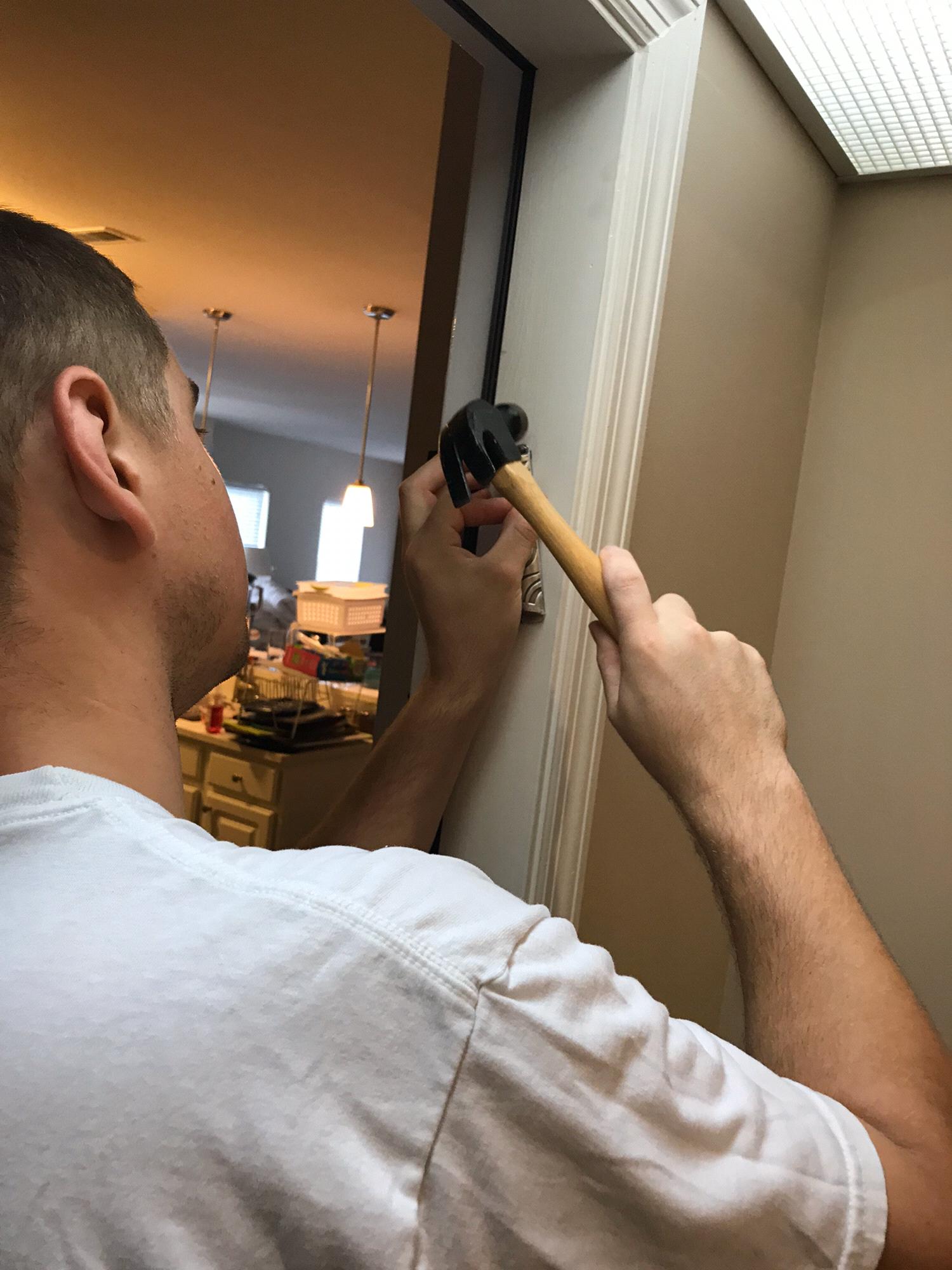 Nate putting up our mezuzah when we moved in together (2018)