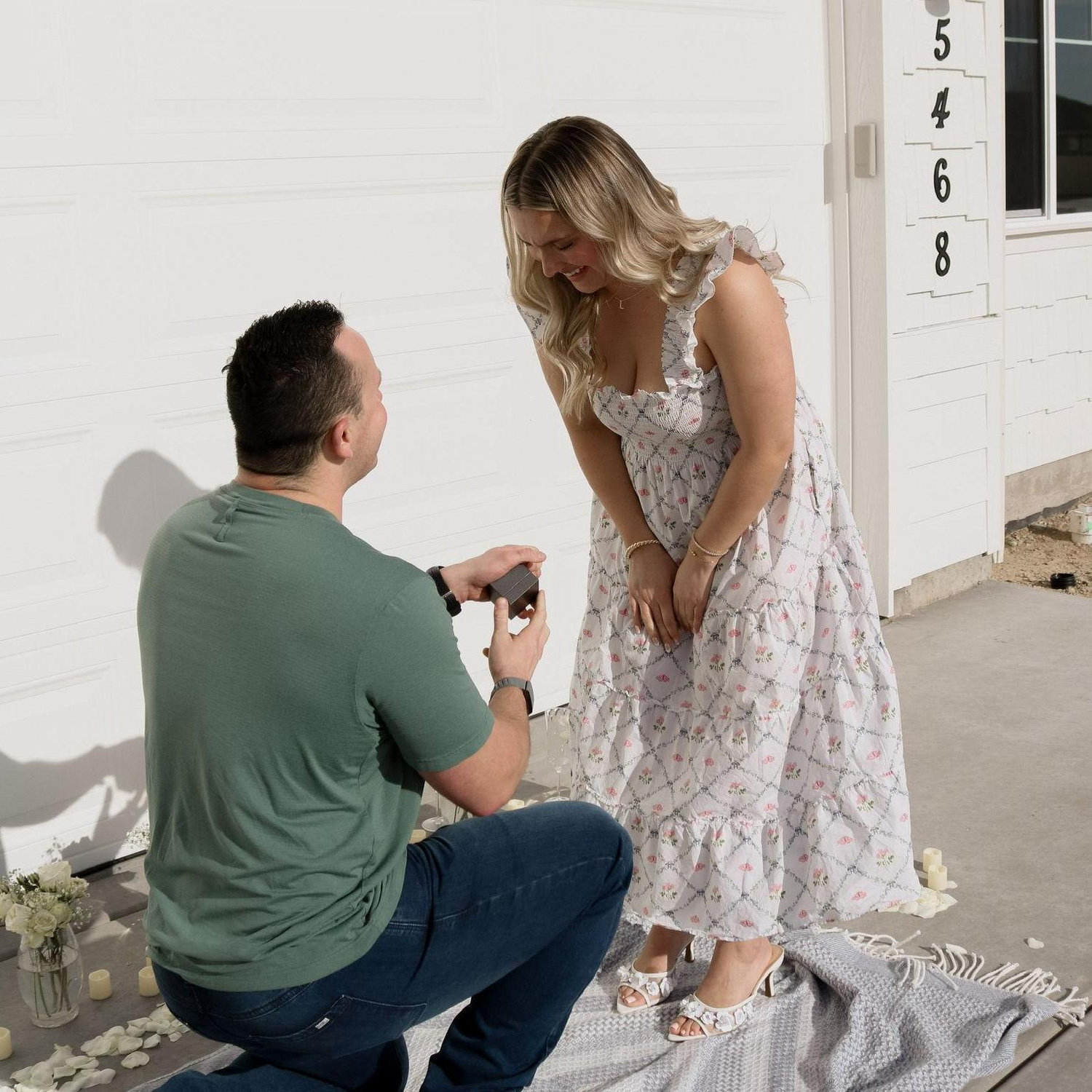 Luke popped the question outside of their new home they built together!