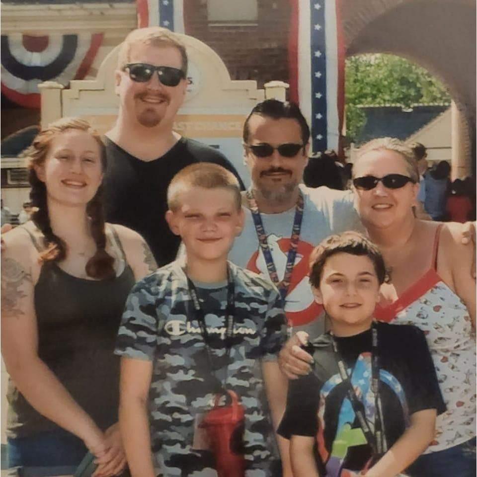 A picture at the Six Flags entrance with family and a friend