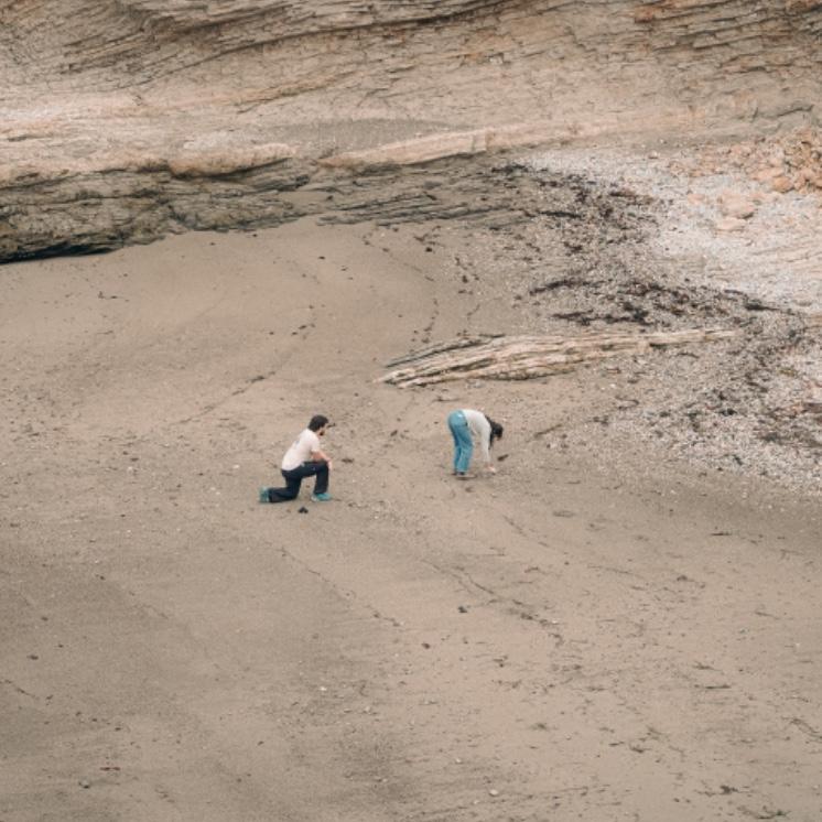Rory looking at rocks while Joel is trying to propose