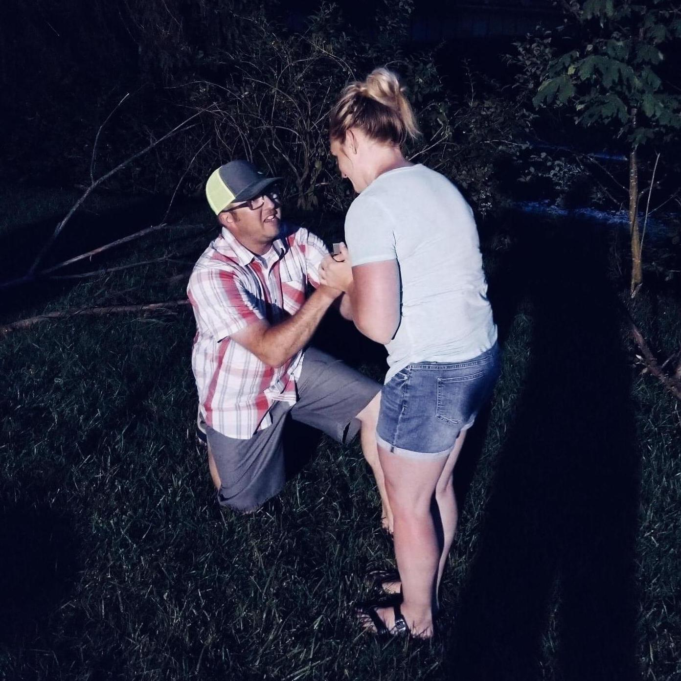 Ryan got down on one knee out by the fire pit of the river house while we were playing yard games.