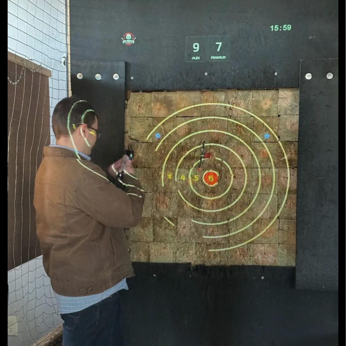 One of our many axe-throwing dates..Franklin is an axe-throwing officianado. He taught Alex everything she knows about weaponry.