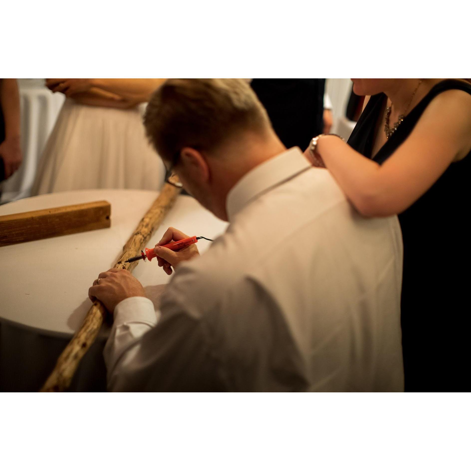 Gregg burning his name in the Camp Tawonga Chuppah pole (Sara and Gregg were married under these same poles in 2014 but never had the chance to put their names on the poles until this night)