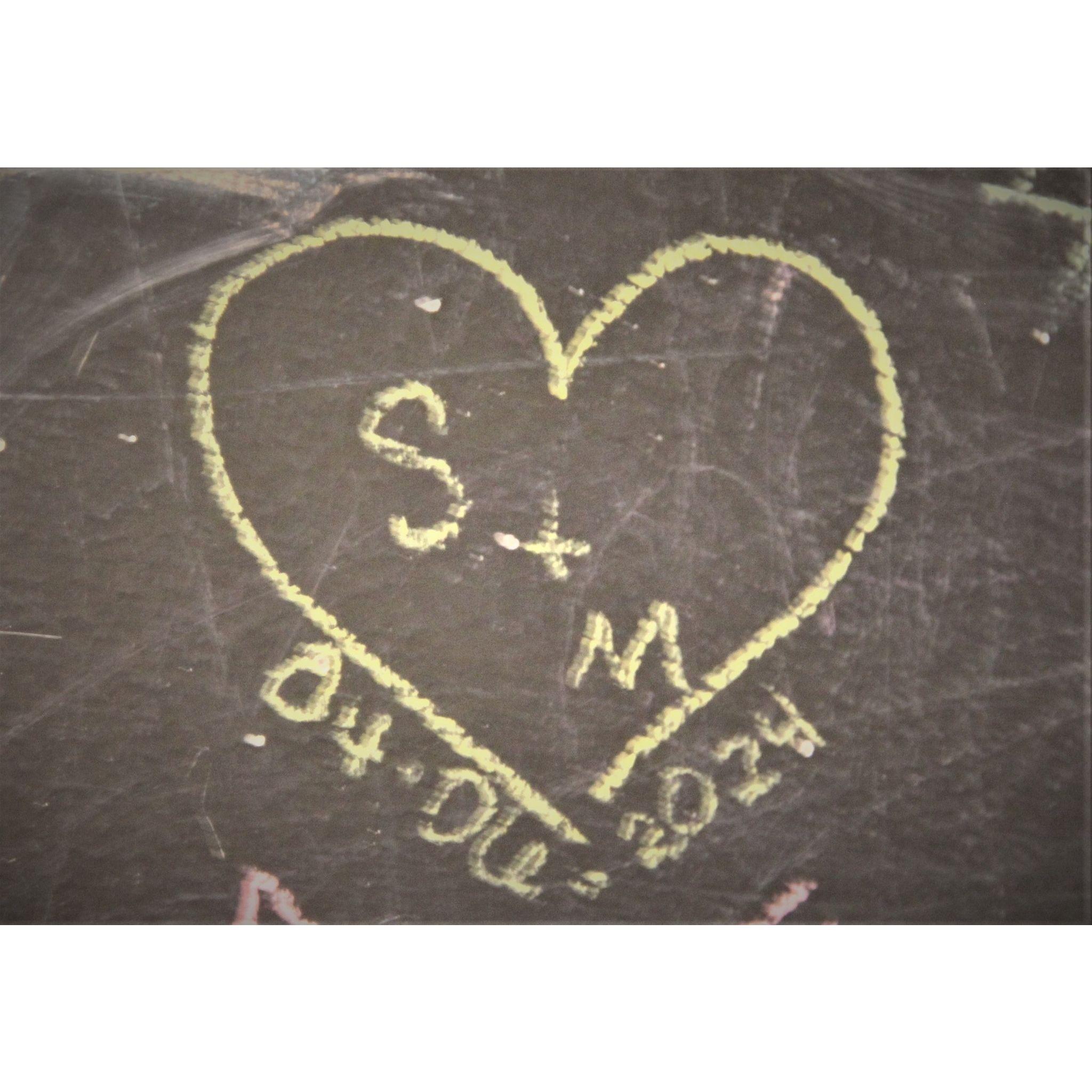 Sean and Madison's favorite ice cream shop has a chalkboard wall, and they have a photo of another heart they drew as each others' contact photos