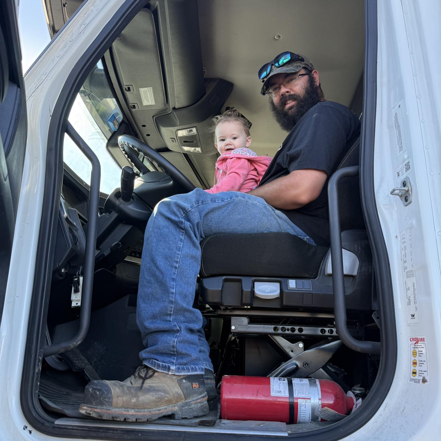Daddy's girl enjoying his work truck