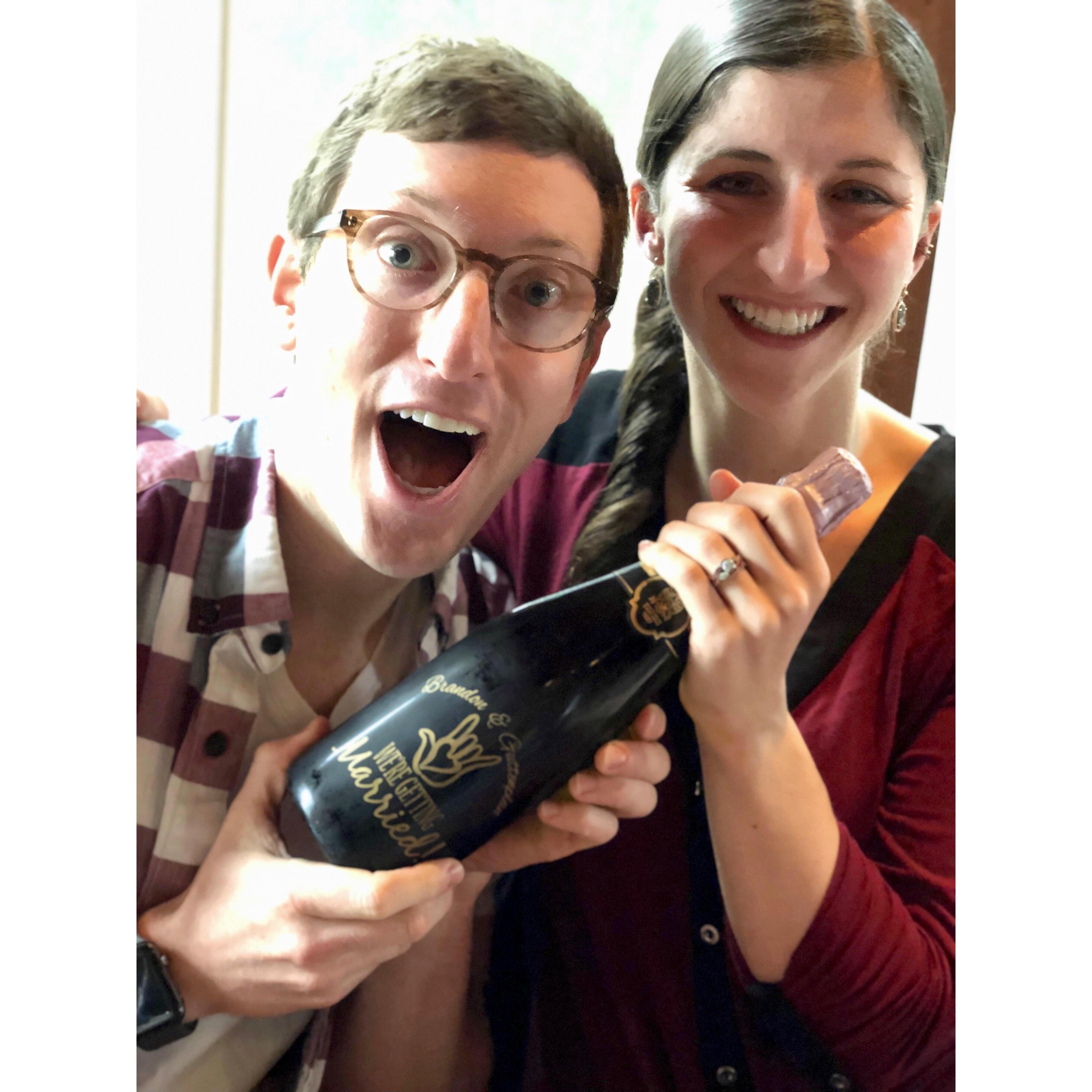 Celebrating our engagement with personalized champagne bottles we made for our families!