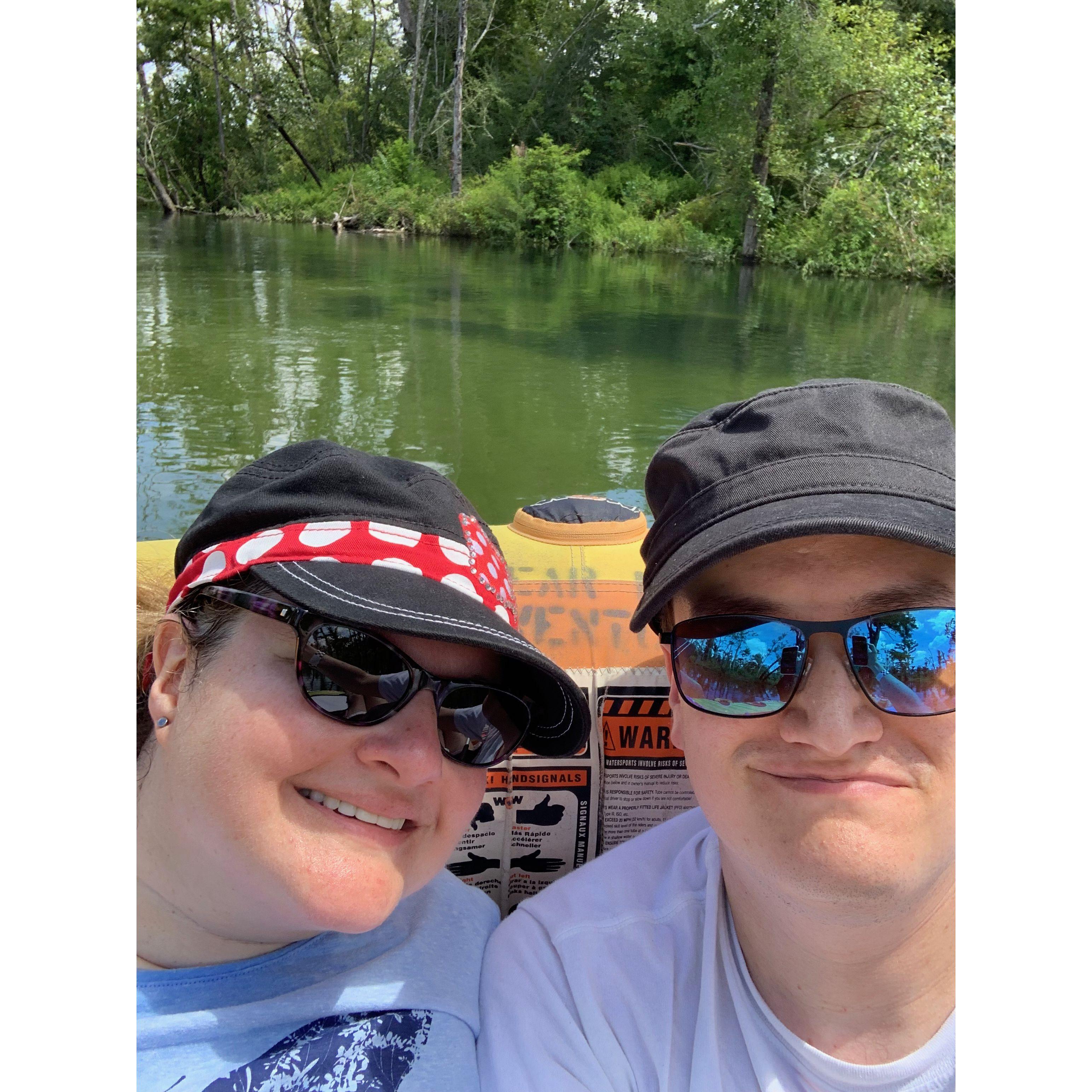 Selfie on a river raft on greenish water.
