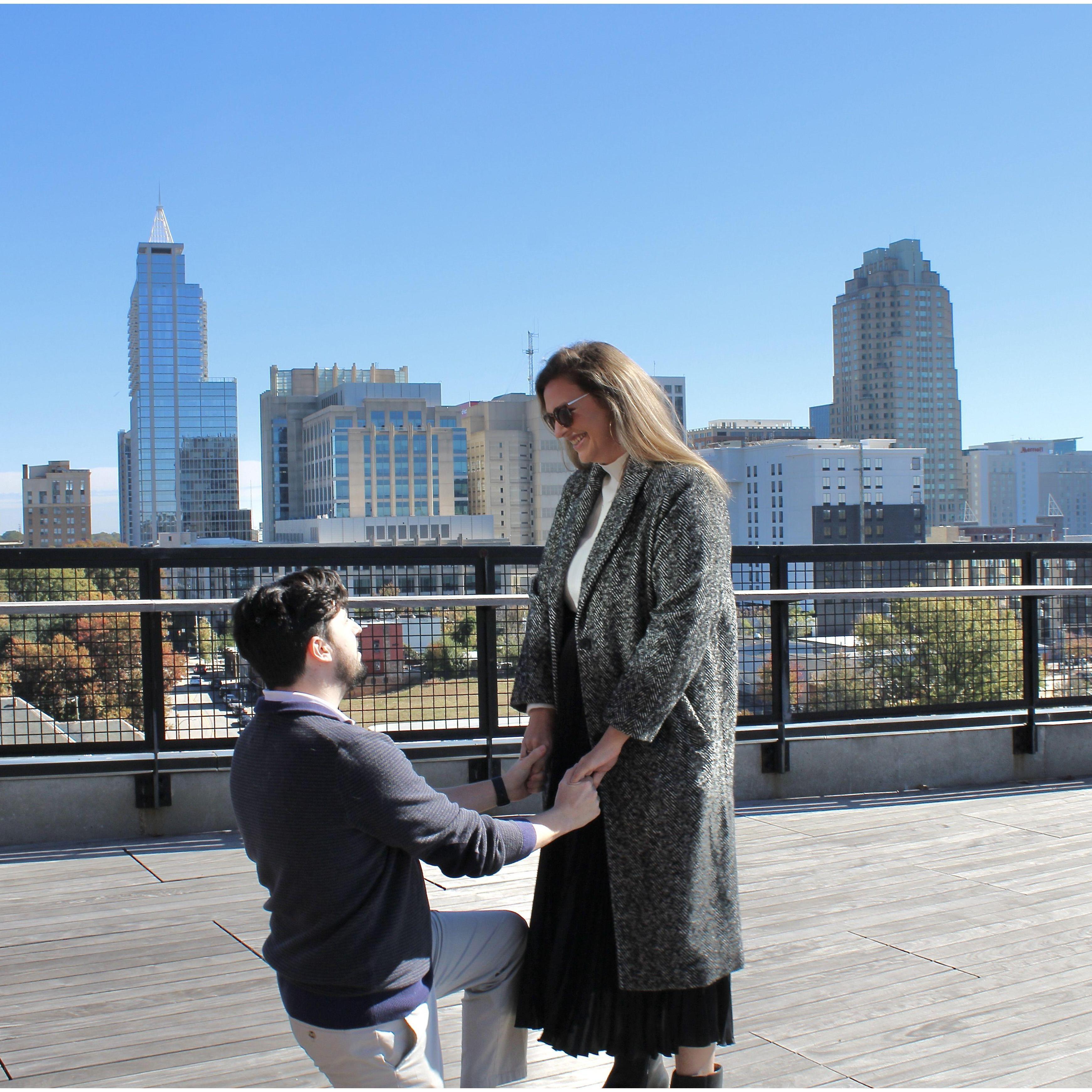 The happiest moment with the most beautiful view of the Raleigh skyline to set the scene!
