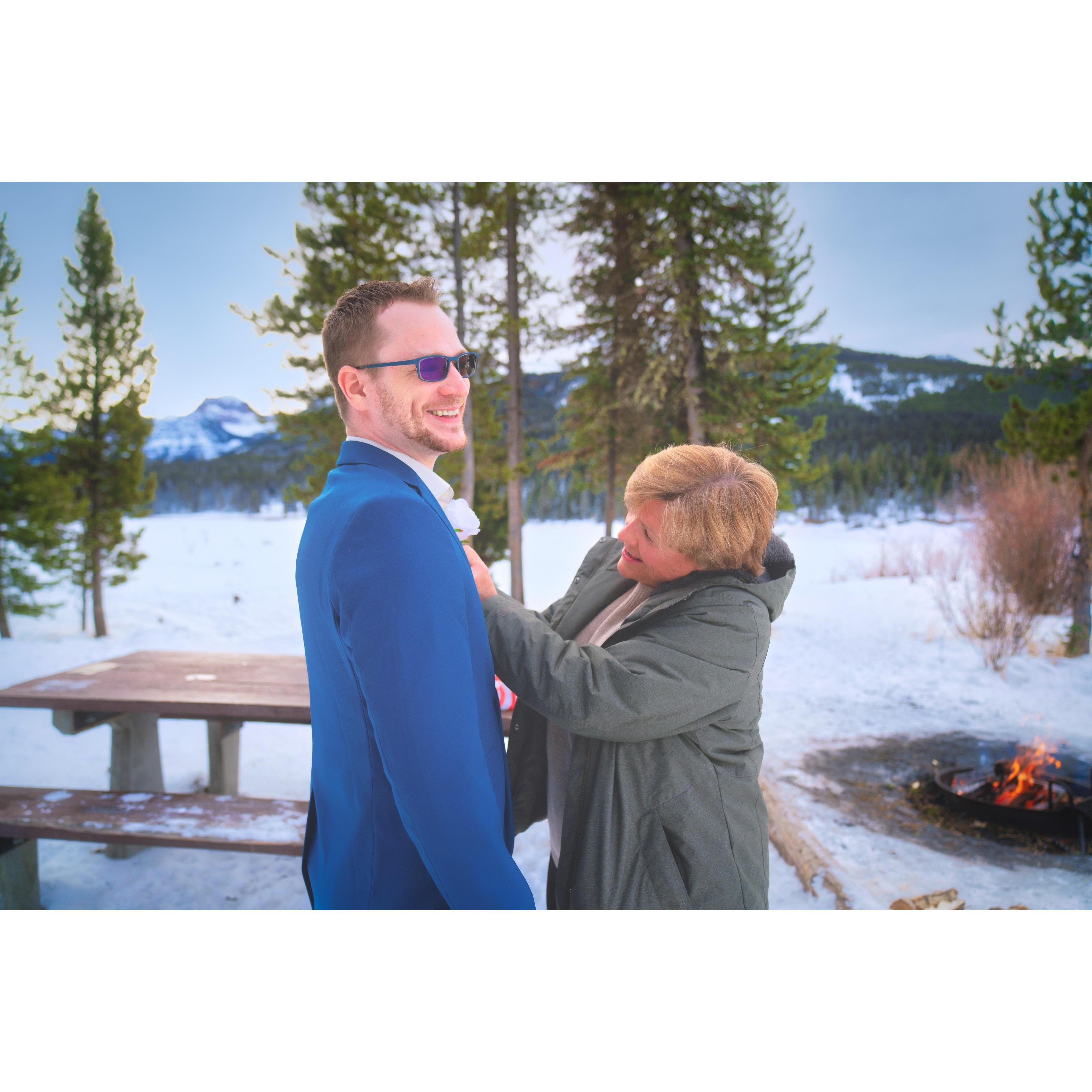 Heather's mom helping Colin with his boutonniere.