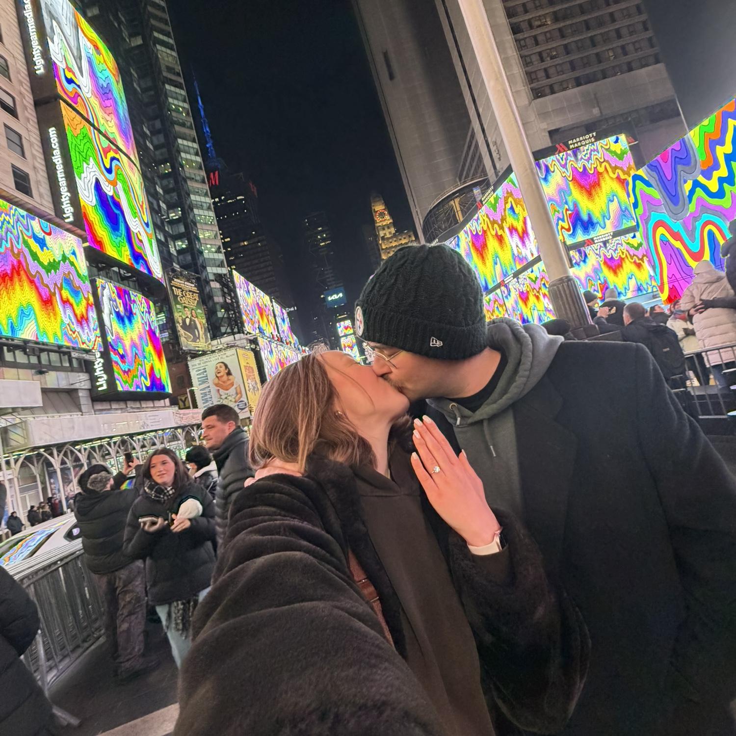 They’re engaged!!!! They went to the New York minute Art show in Times Square at midnight, right after Will proposed. Once the Art show was over Maria yelled, “we’re engaged!!”