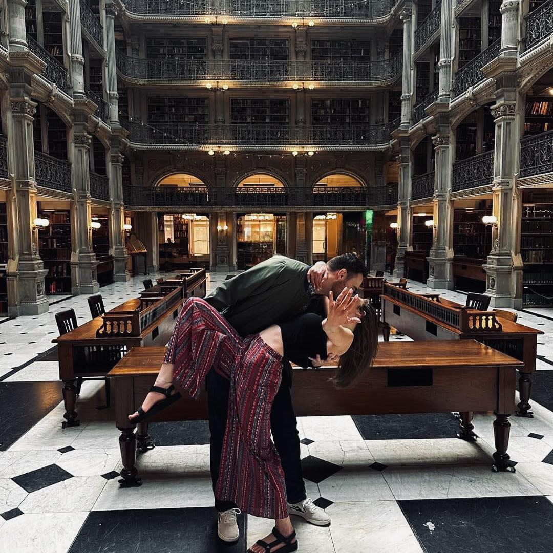 Aaron proposed to Emily at the George Peabody Library. He wanted to include all of the things Emily loves in the proposal; surprises, books, and her favorite girls, Harper, Addie, and Rachel.
