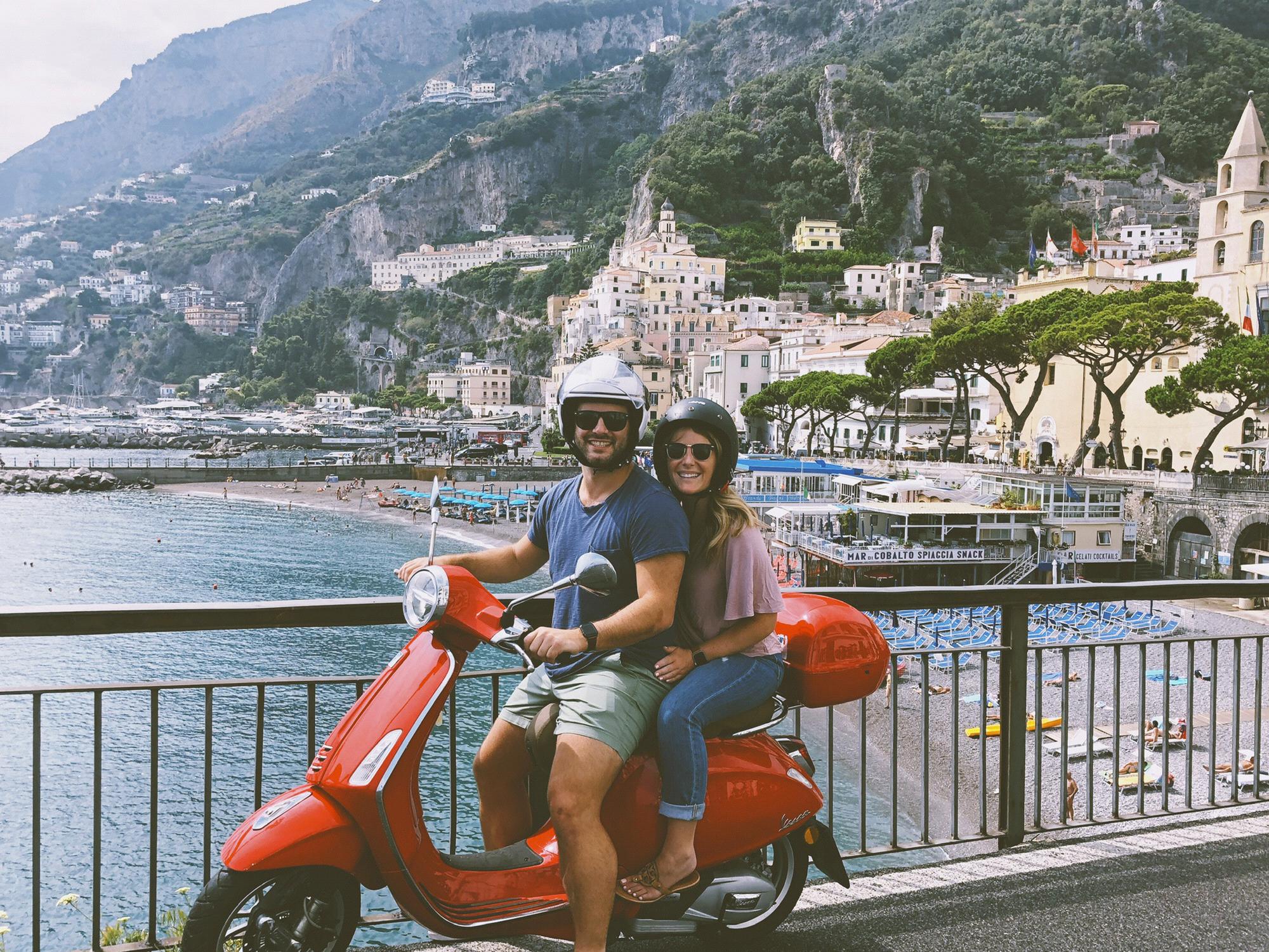 Us on our red Vespa Primavera with Atrani in the background