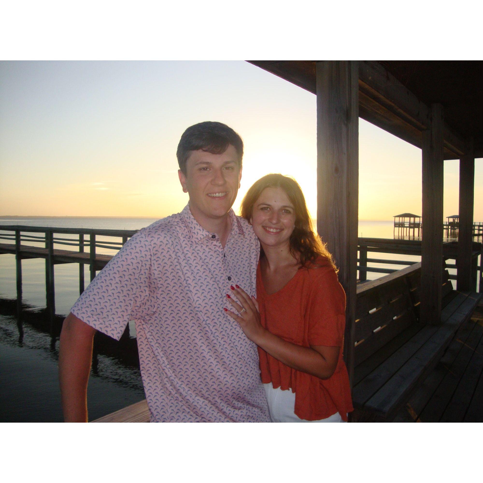 Posing on a dock in Duck, the place we got engaged