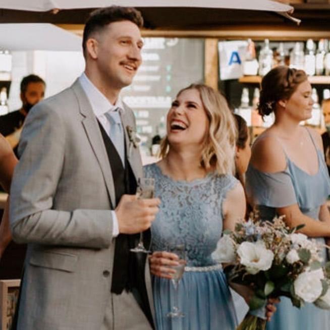 A candid photo of us at my sister's wedding. We were best man/maid of honor and had just started dating a couple of months back!