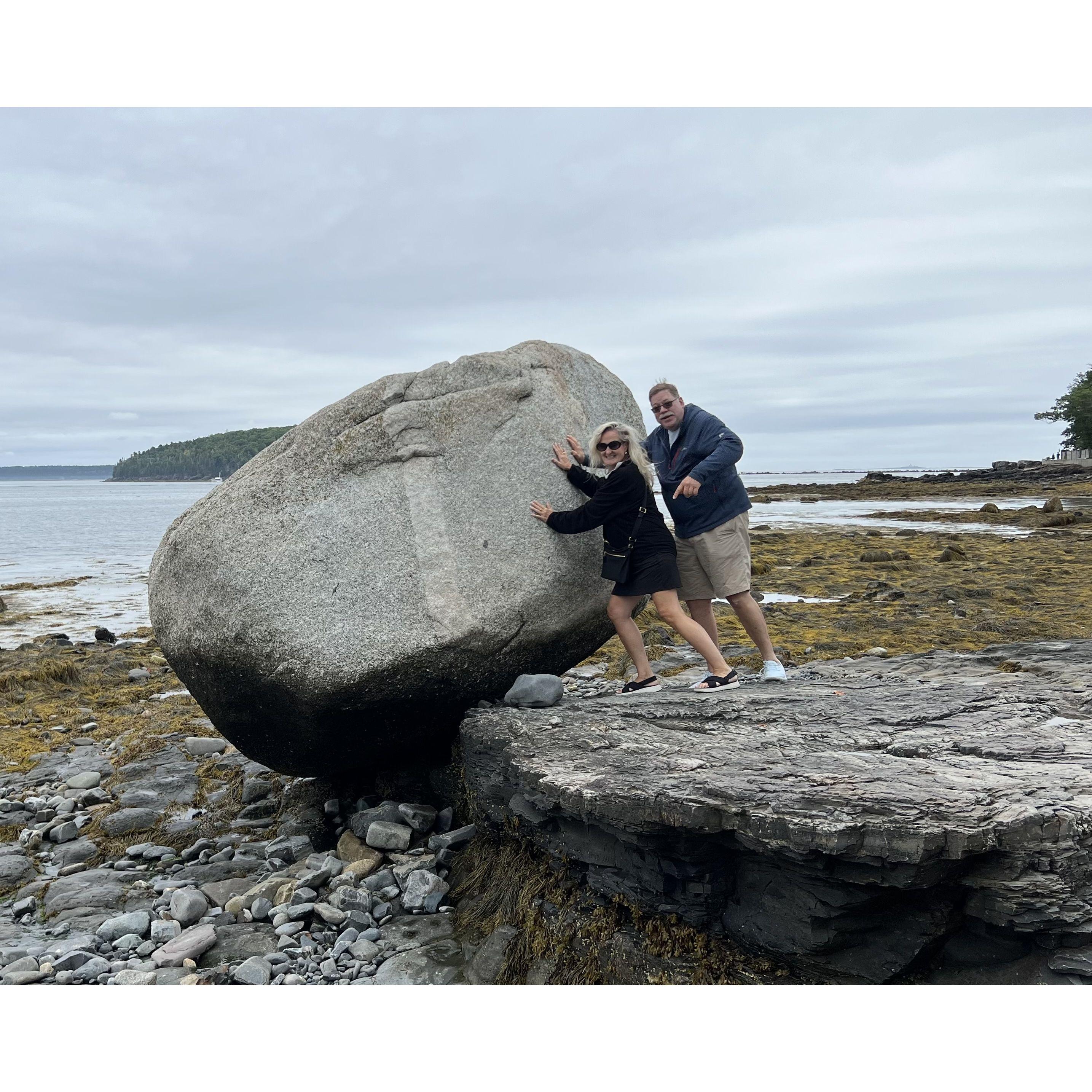 Pushing a rock down the beach in Bar Harbor.