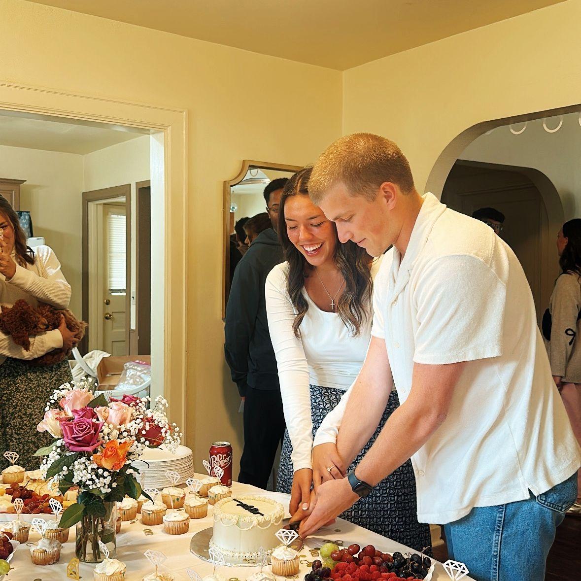 at our engagement party cutting the cake!