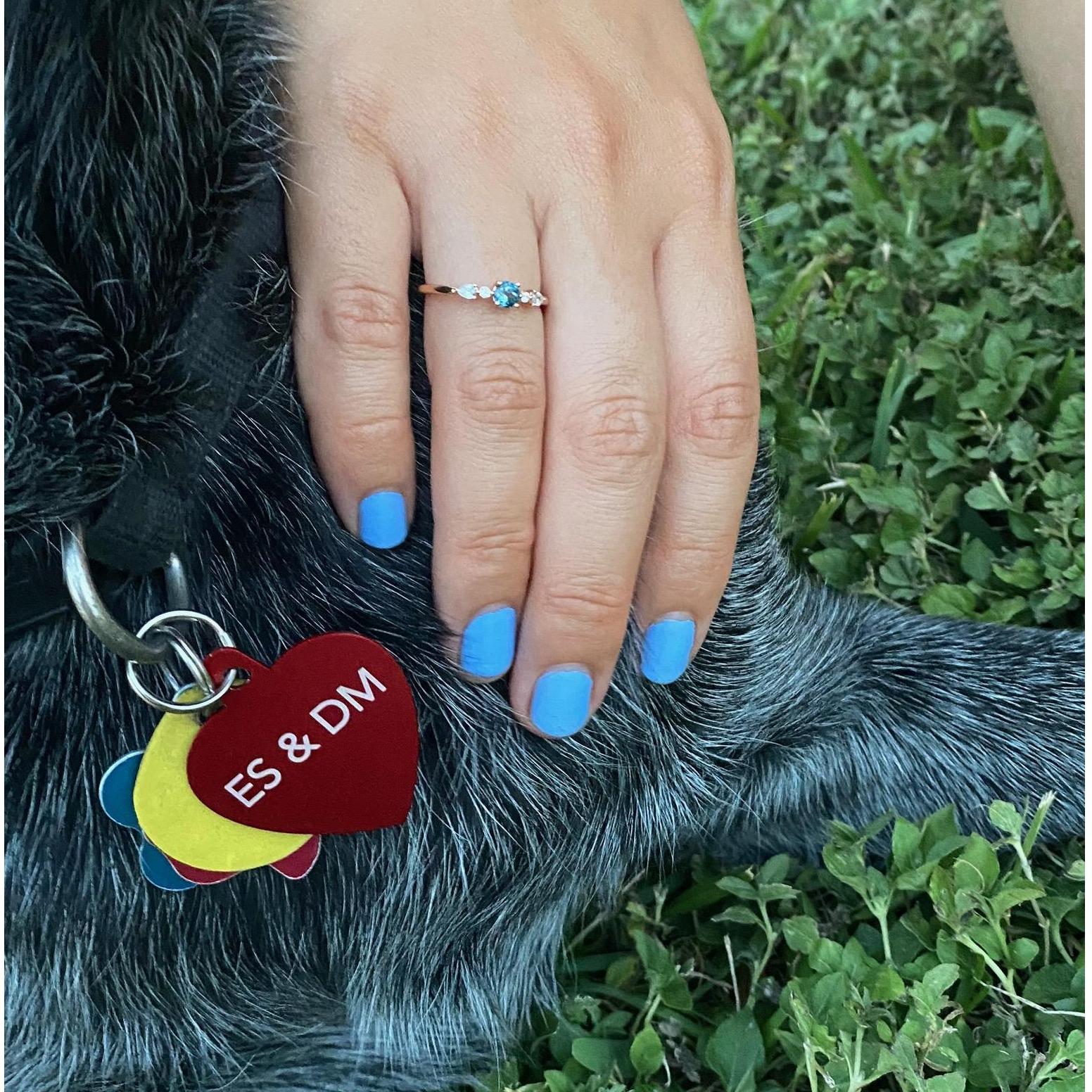 The ring is rose gold with a rose-cut blue topaz and some teeny-tiny diamonds. Sarge refuses to take off his engagement tag as long as mom gets to wear her ring.