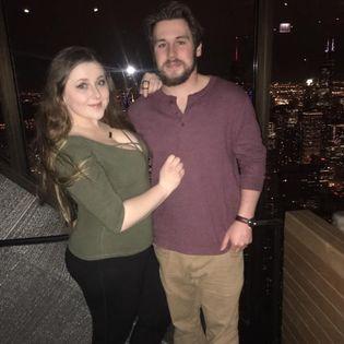 The pair posing by the Chicago night skyline.