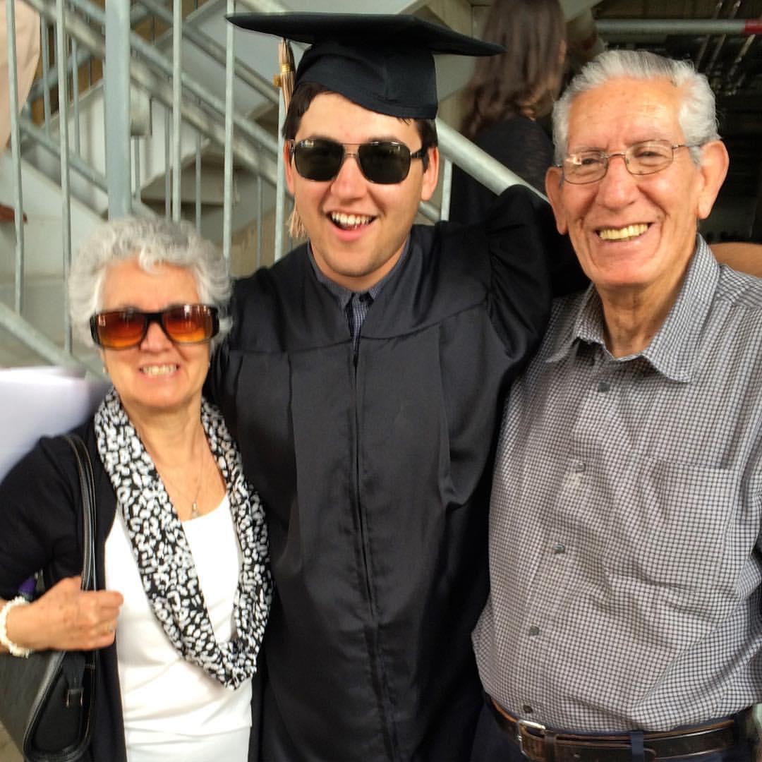 Robert graduates with his bachelor's degree and celebrates with his grandparents, May 2016.
