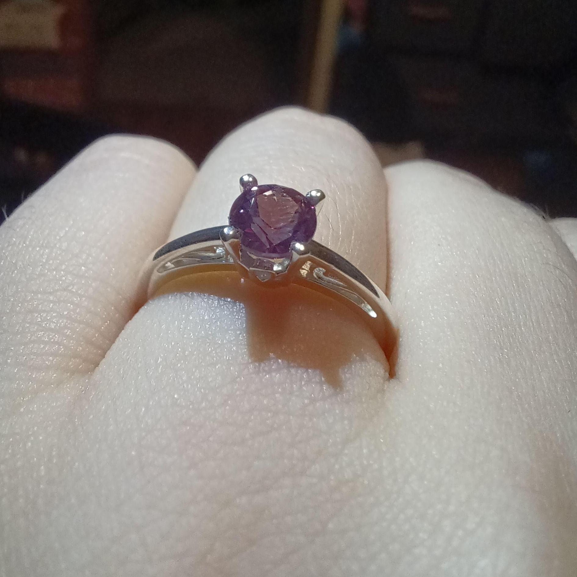 Engagement Ring: A round-cut purple sapphire