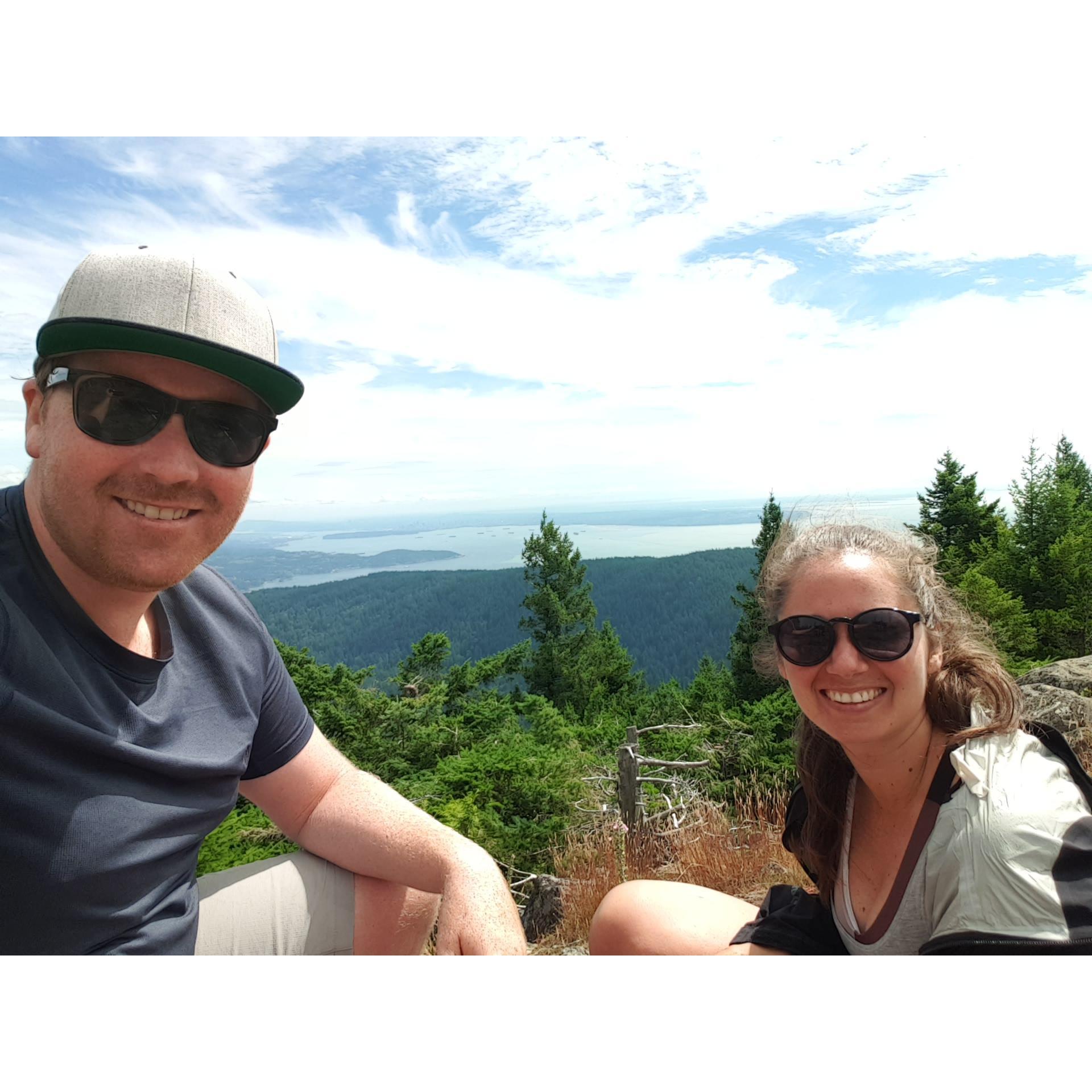 The summit of one of our dozens of hikes we love to do together. This is the peak on Bowen Island looking back towards Vancouver.