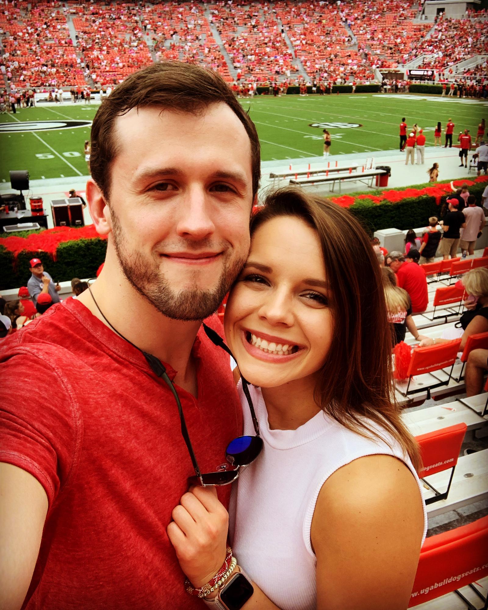 Laura dragged Luke to a Georgia Game and he graciously wore red! September 2019