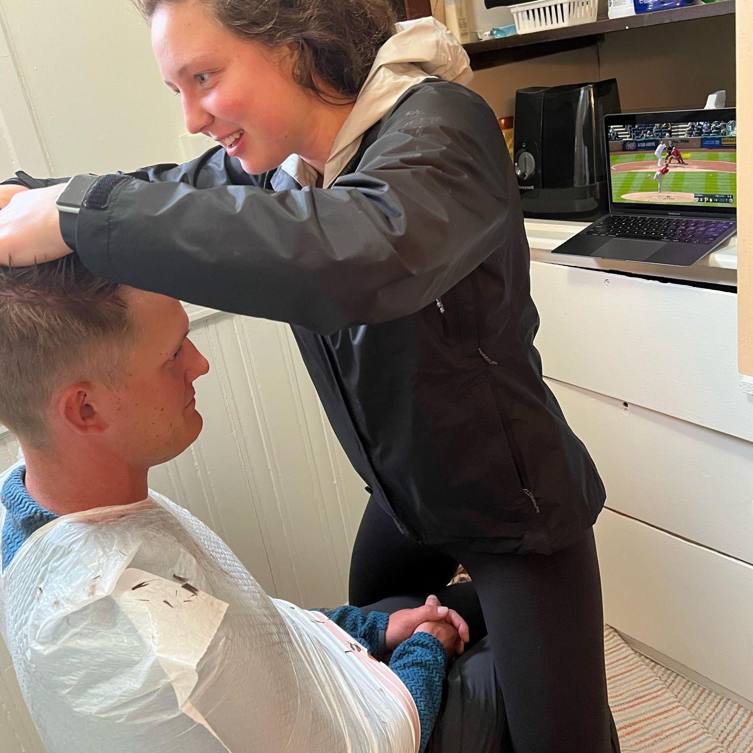 Rowan learned to cut a "high and tight" so Ben now has a barber for life. We have upgraded from squeezing a garbage bag around Ben to using a real barber cape.