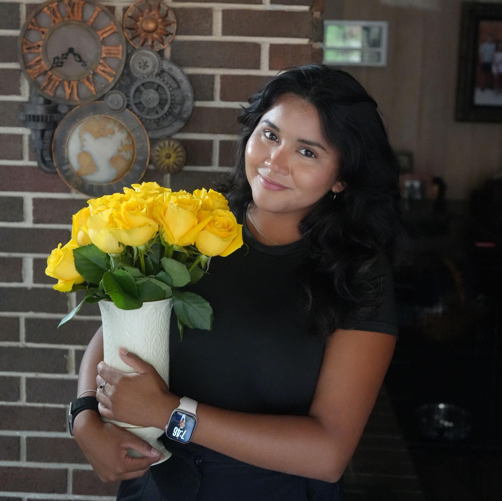 8/11/25: Jackie with the flowers Nate got her for her first day back at work after taking the Bar!