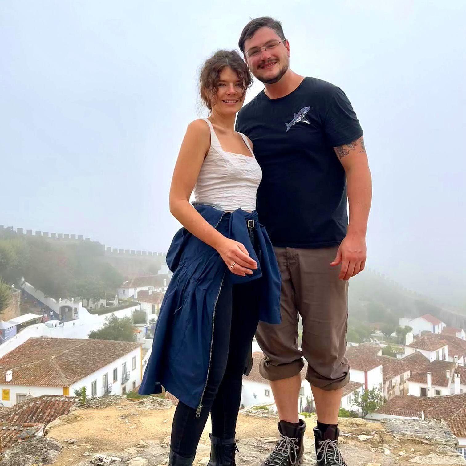 Standing on the foggy castle walls of Obidos, Portugal