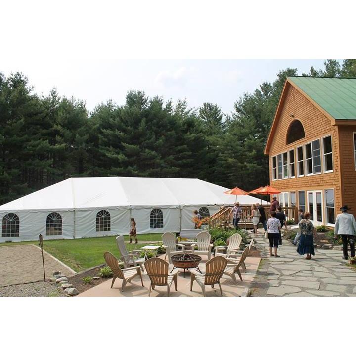 Main lodge, group fire pit area, and reception tent
