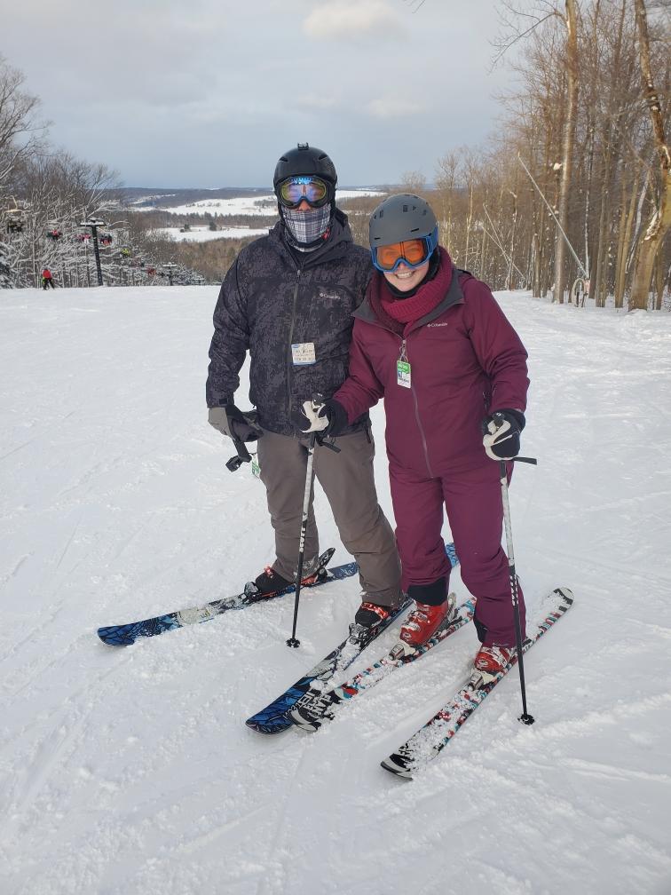 Alex trying to teach Jill how to ski
