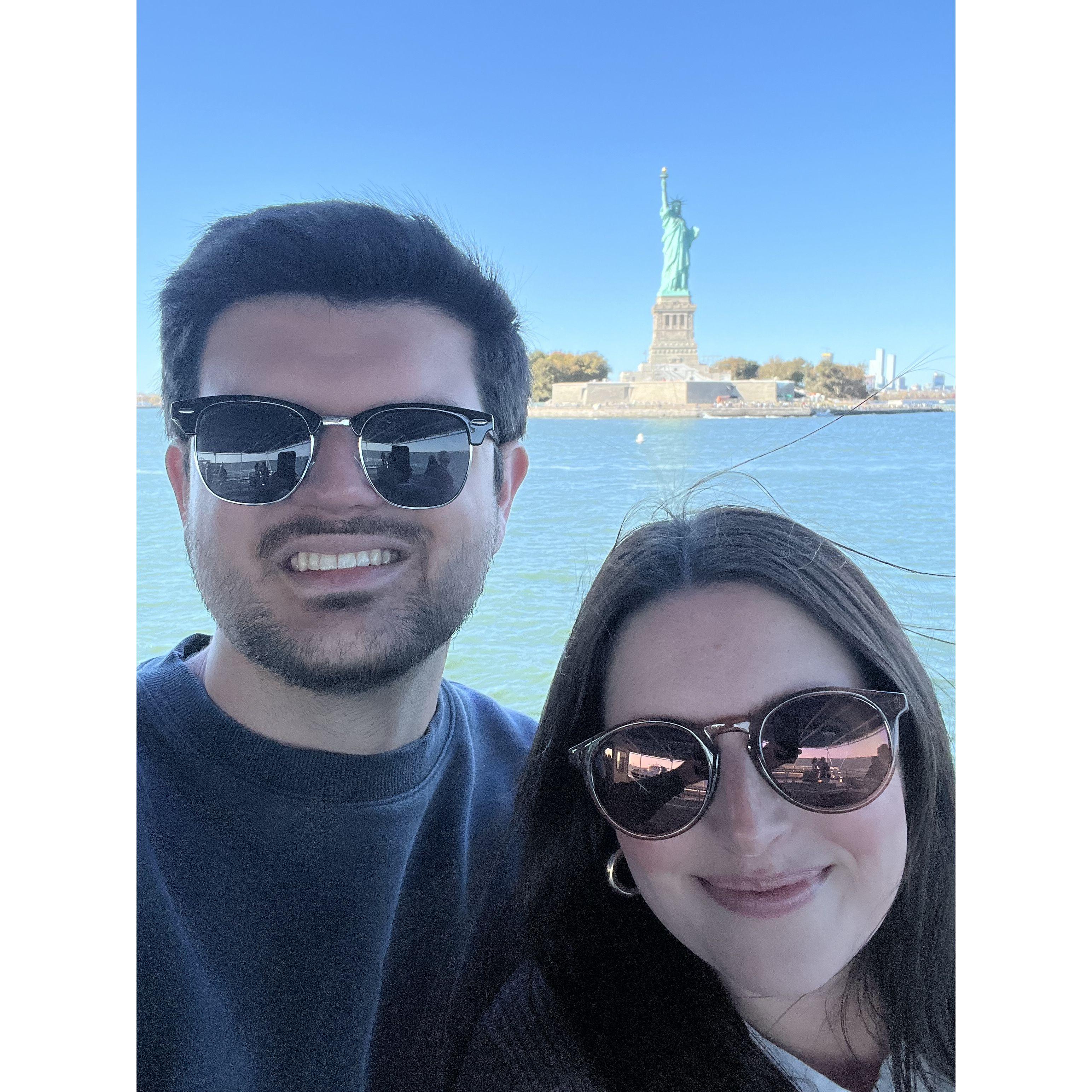 On a sightseeing tour in front of the Statue of Liberty