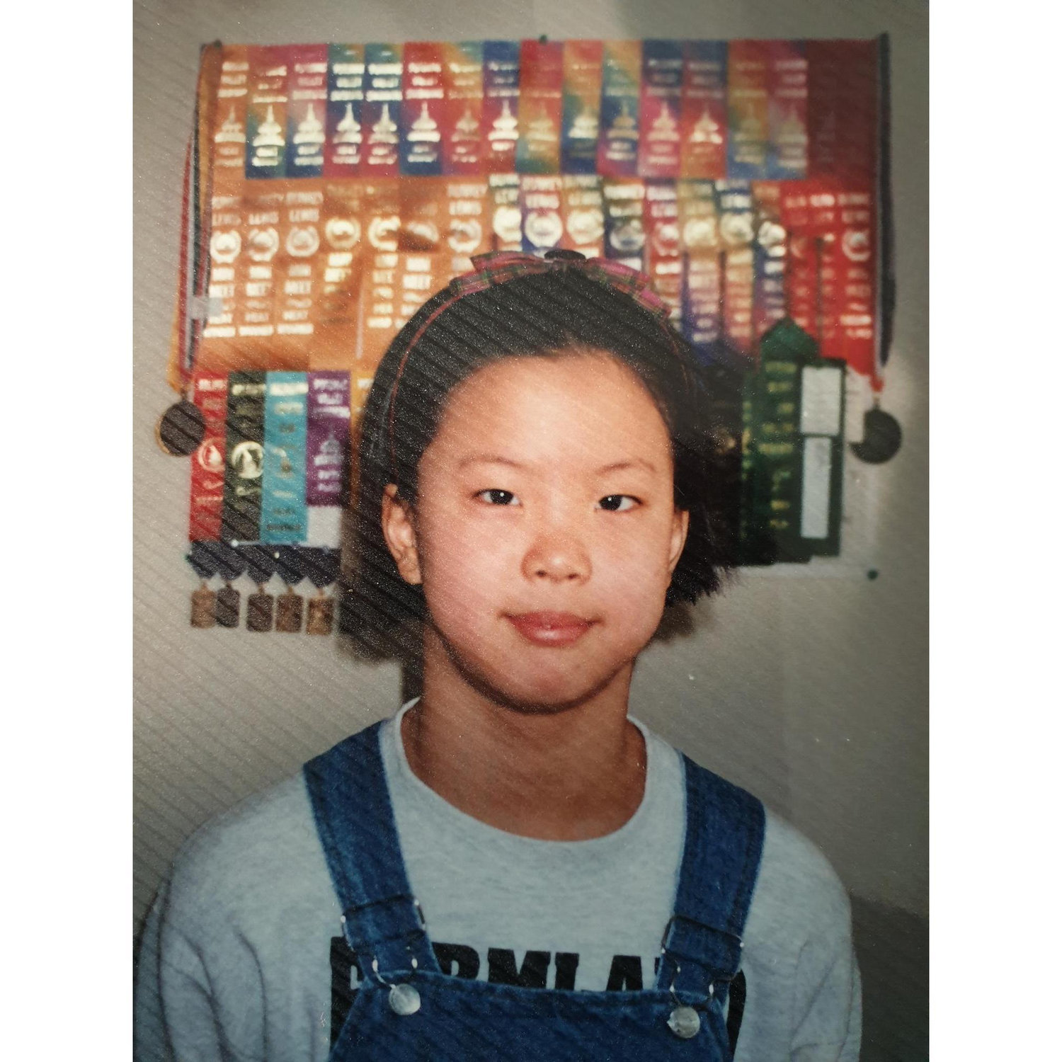 Awkward HeeJin in front of her swimming ribbons!