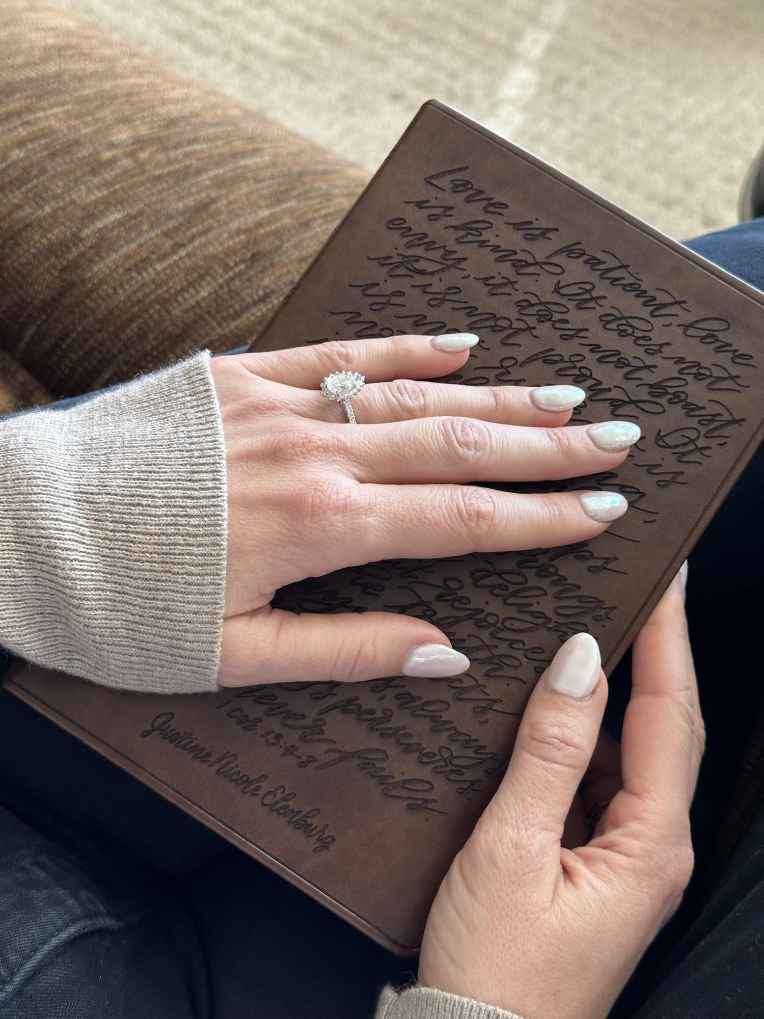 Taylor proposed on Christmas morning with a gift to Justine; a Bible with her name embroidered on the front, but instead with Taylor’s last name of “Elenburg”.