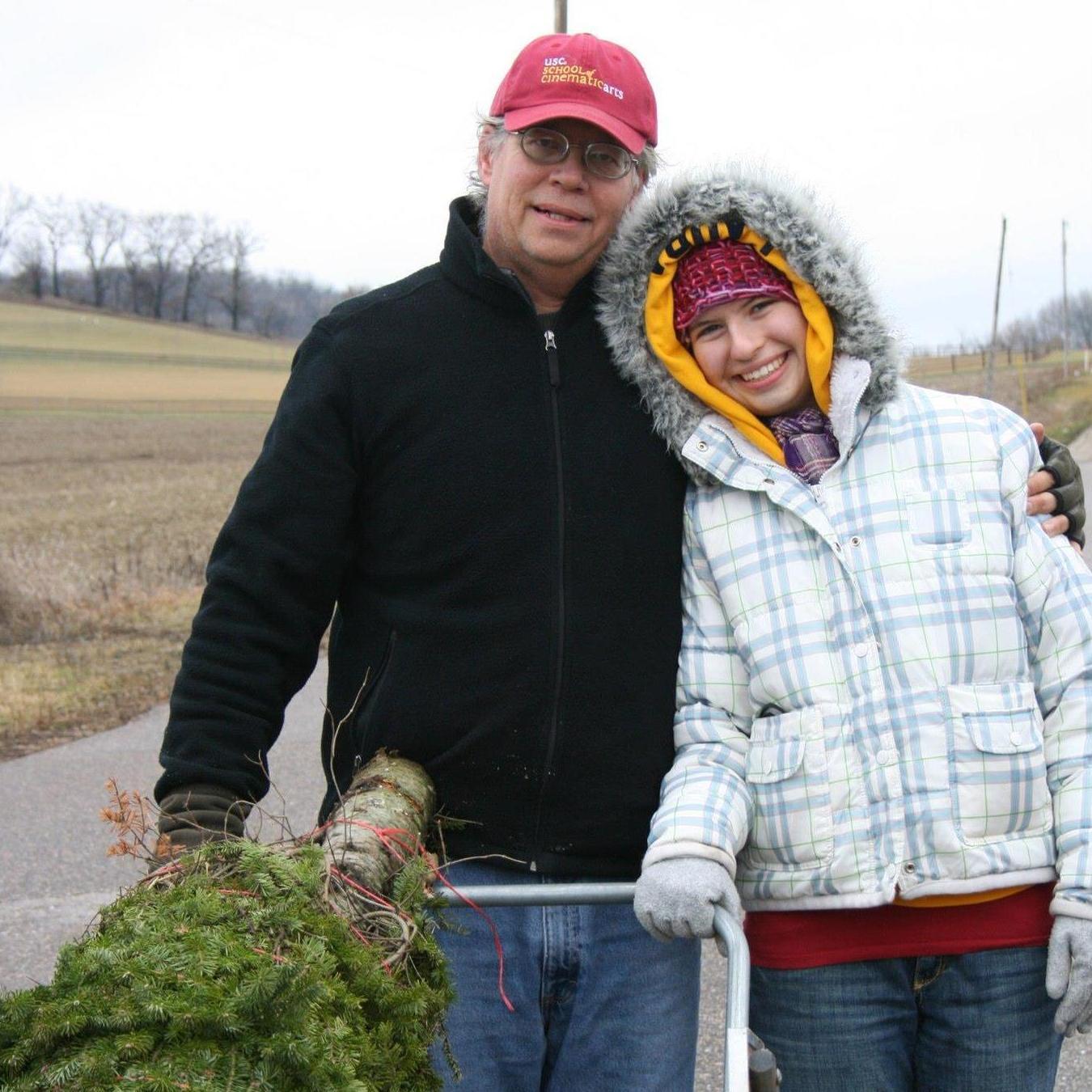 Laura's family had a tradition of walking to pick out a Christmas tree and rolling it home in a cart.