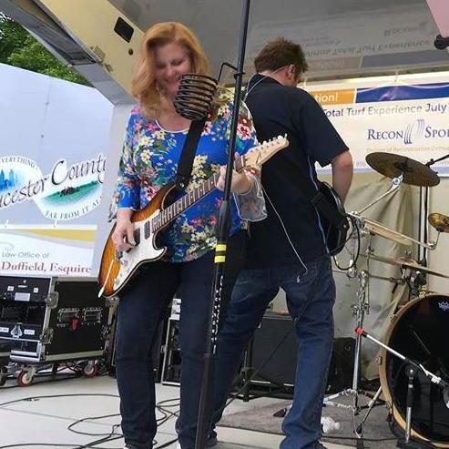 Wen showing Rob how it's done on guitar.