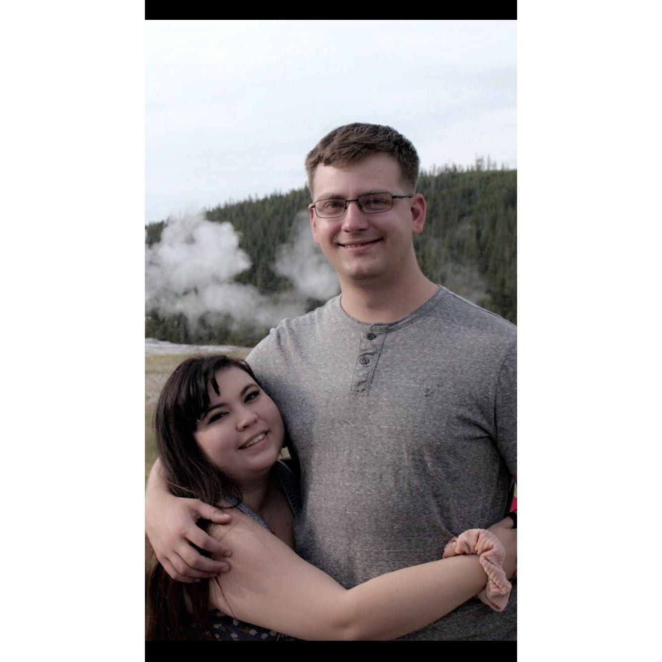 Us in front of Old Faitful in Yellowstone National Park