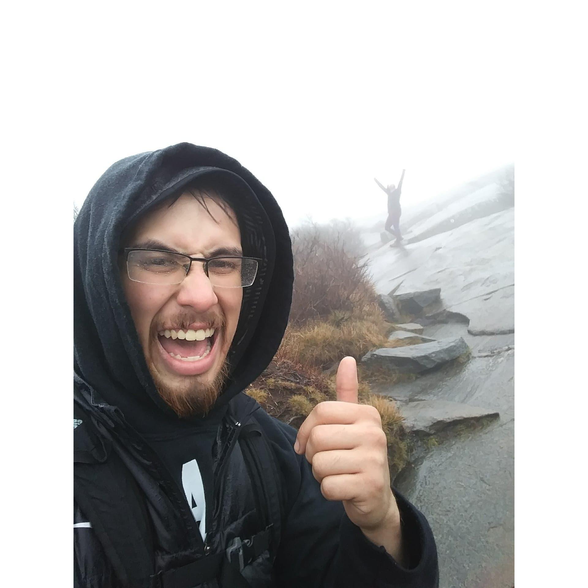 Started raining on our hike as we were almost to the top. We pressed on and this is our victory photo at the peak!