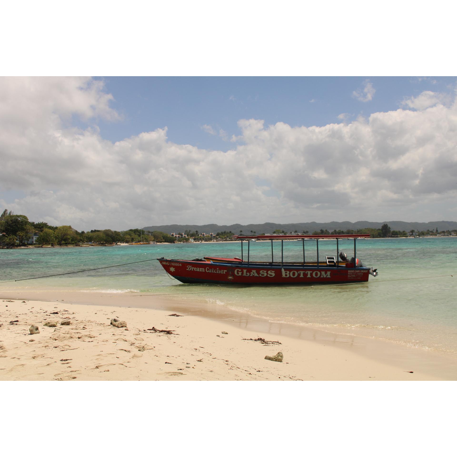 Glass bottom boat that takes you to Island Picnic or Ricks Cafe