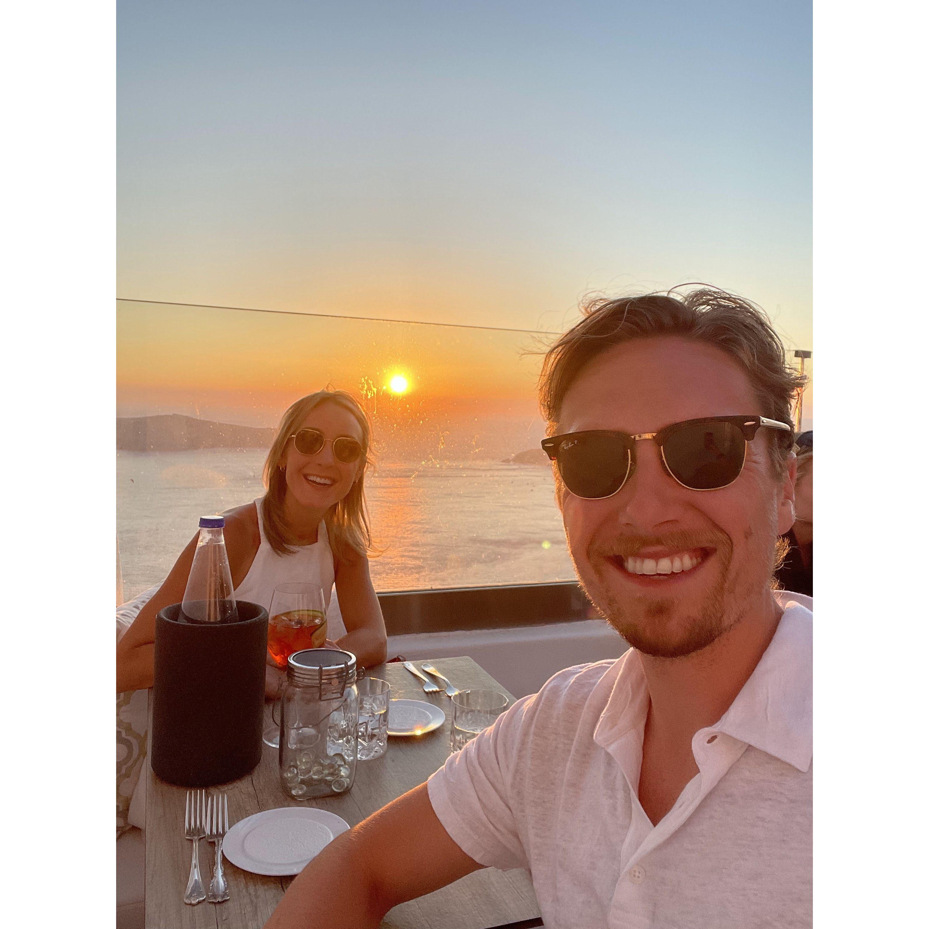 Our first international trip together to Greece! Enjoying a yummy meal in Santorini and taking in the beautiful sunset!