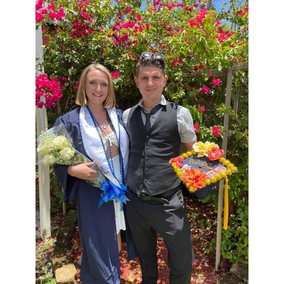 Angelo supporting Bailey at her college graduation in May of 2021.
